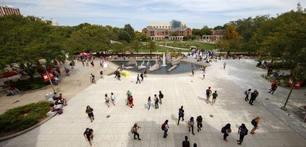 Students walking on the common space behind the the City Campus Union.