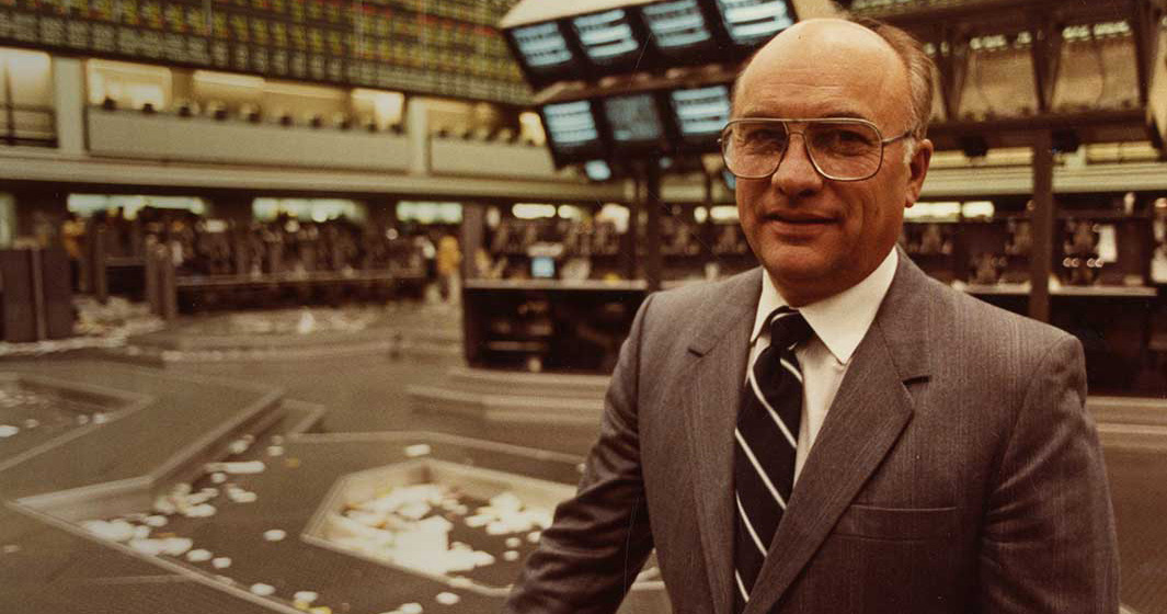 Clayton Yeutter standing on the floor of the New York Stock Exchange.