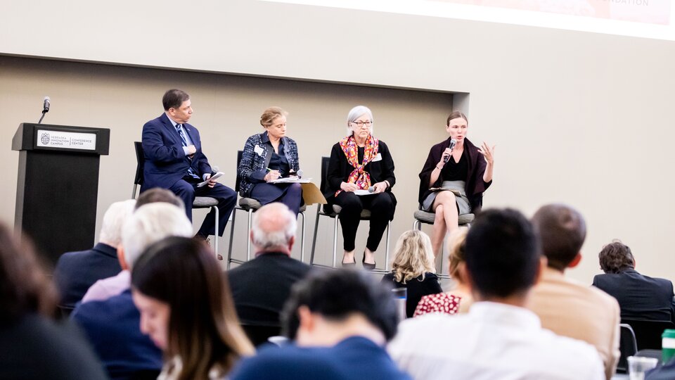 Kathleen Claussen speaking on a panel in front of audience