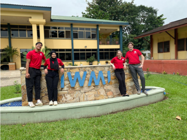 People in front of sign